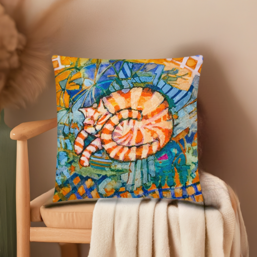Sleeping ginger cat pillow with colorful artistic design on chair