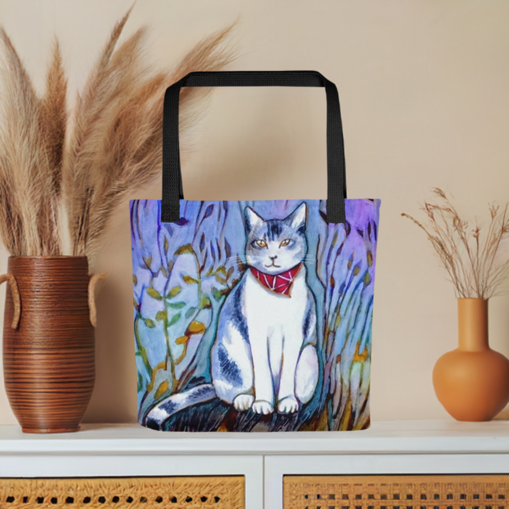 Cat in Scarf Tote bag featuring colorful cat artwork by Joy Calonico with black handles on a shelf background