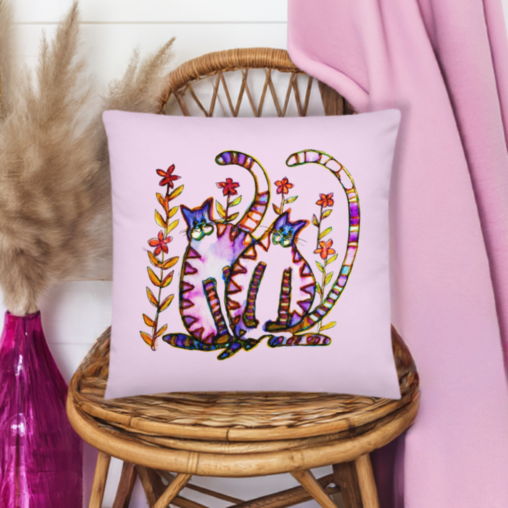 Two Cats Pink Pillow with colorful cat artwork on soft polyester case on wicker chair