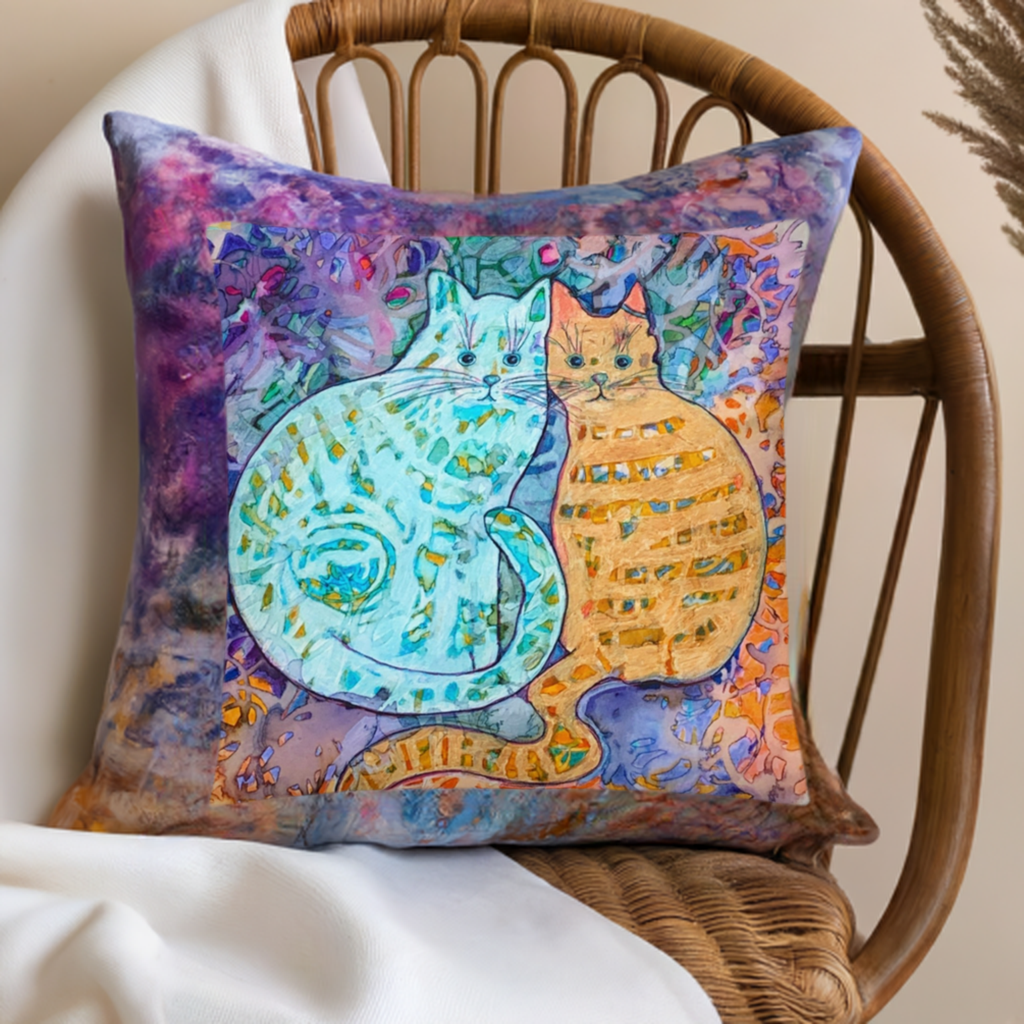 Colorful Cat Friends Pillow with artwork by Joy Calonico on wicker chair