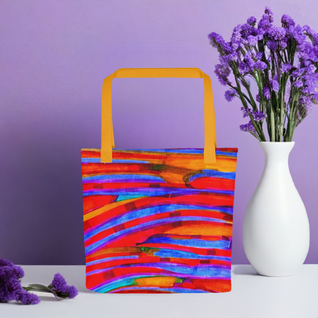 Gentle Slopes Abstract Tote bag with vibrant colorful abstract design and yellow handles against purple background with flowers