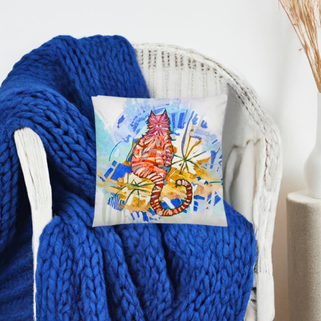 Garden Cat Pillow with colorful cat artwork on white pillow on chair with blue knitted blanket