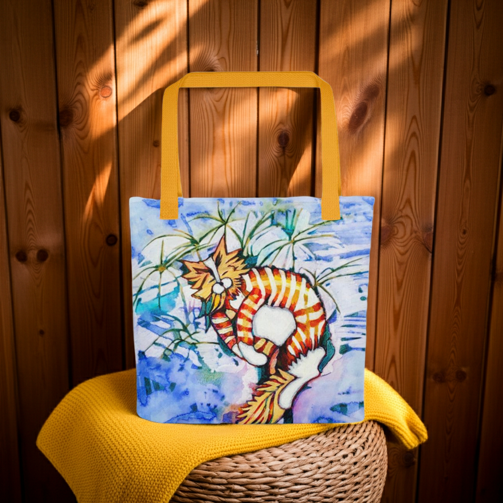 Orange Tabby Cat Tote bag with colorful cat artwork and yellow handles on wooden background