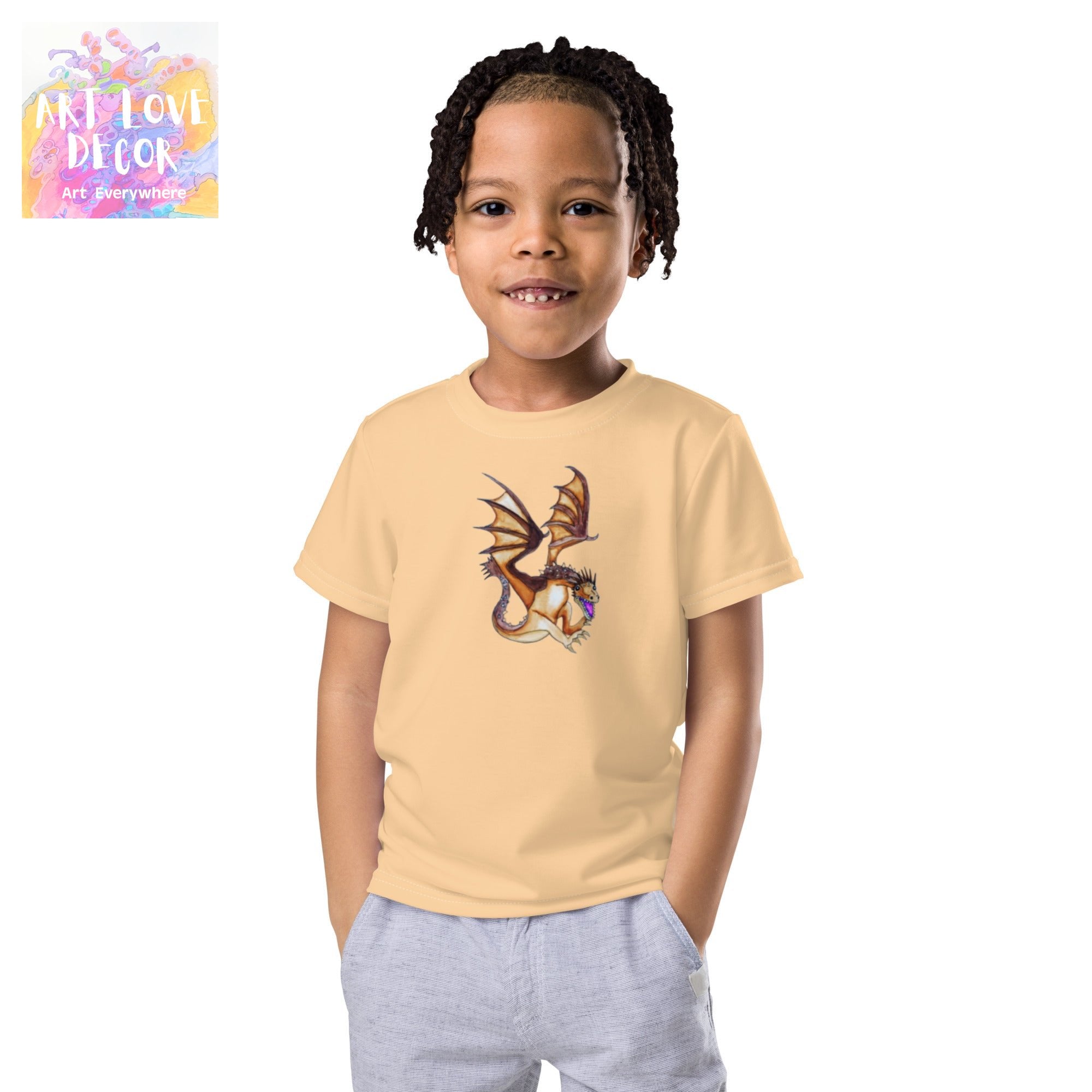 Child wearing beige Dragon Kids crew neck T-shirt with colorful dragon artwork by Joy Calonico