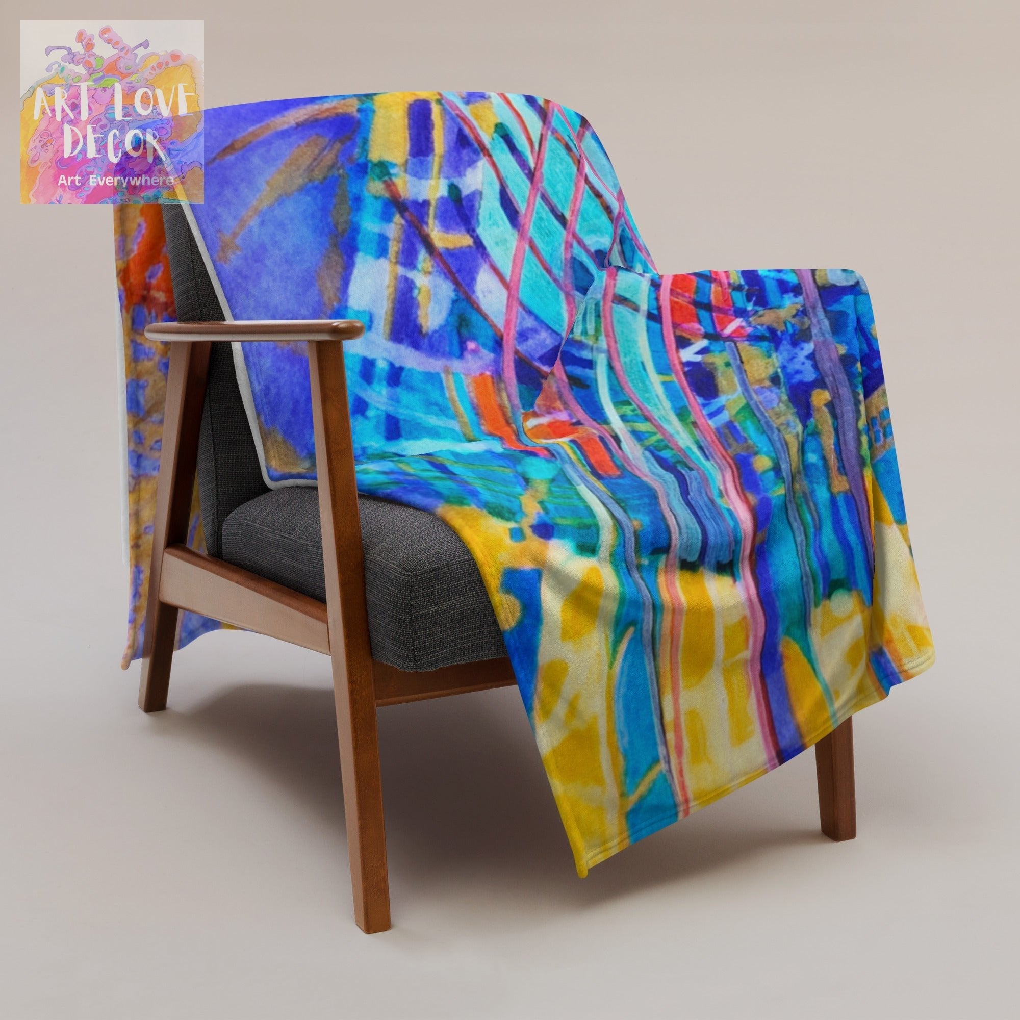 Ray of Hope Abstract Throw Blanket with vibrant colorful abstract art draped over modern wooden armchair