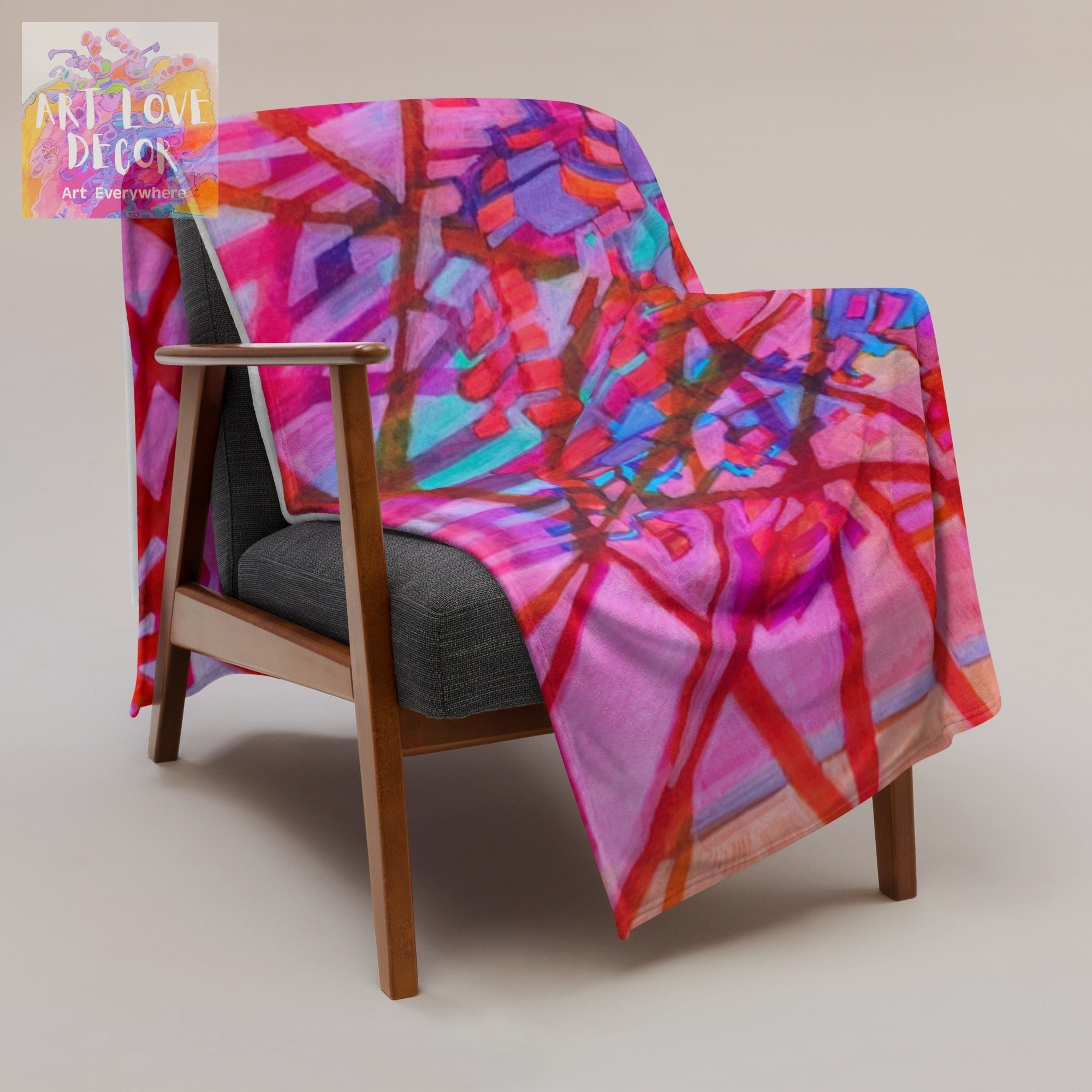 Separation Abstract Throw Blanket with vibrant red and purple abstract design draped over wooden chair