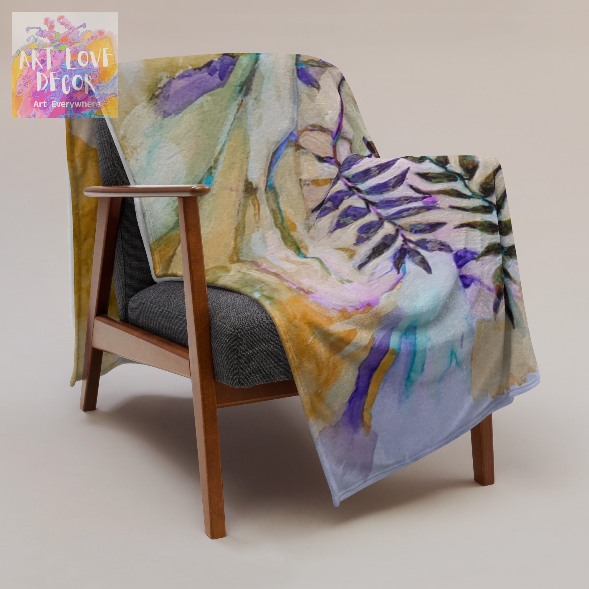 Dry Trail Leaves Throw Blanket with colorful leaf design draped over modern wooden armchair