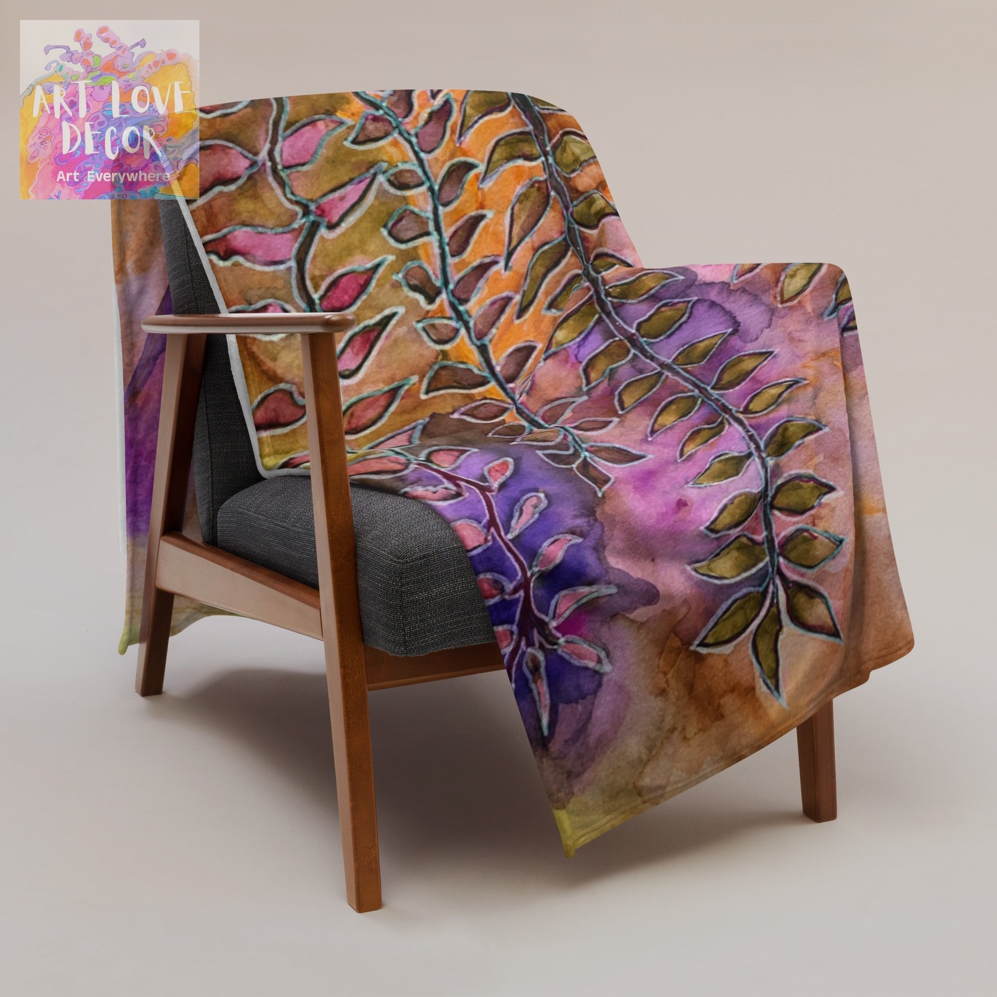 Night Street Leaves Throw Blanket with vibrant leaf artwork draped over a modern wooden armchair
