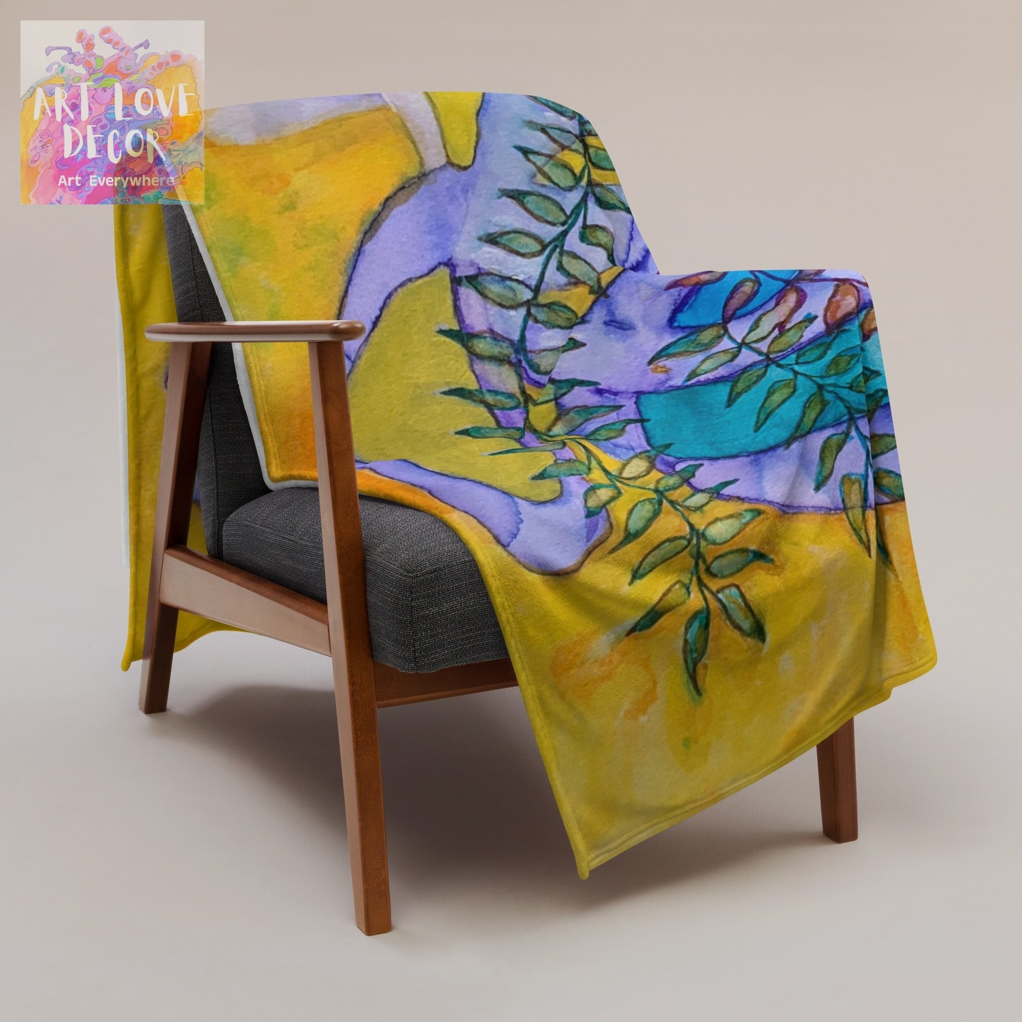Golden Leaves Abstract throw blanket with soft silk touch fabric draped over modern wooden armchair